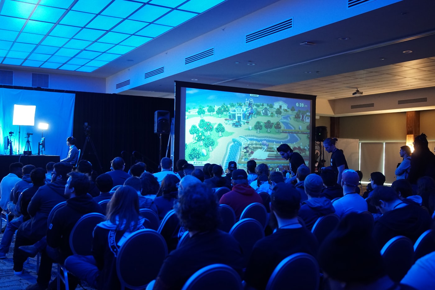 Attendees seated before a stage at a technology community event.